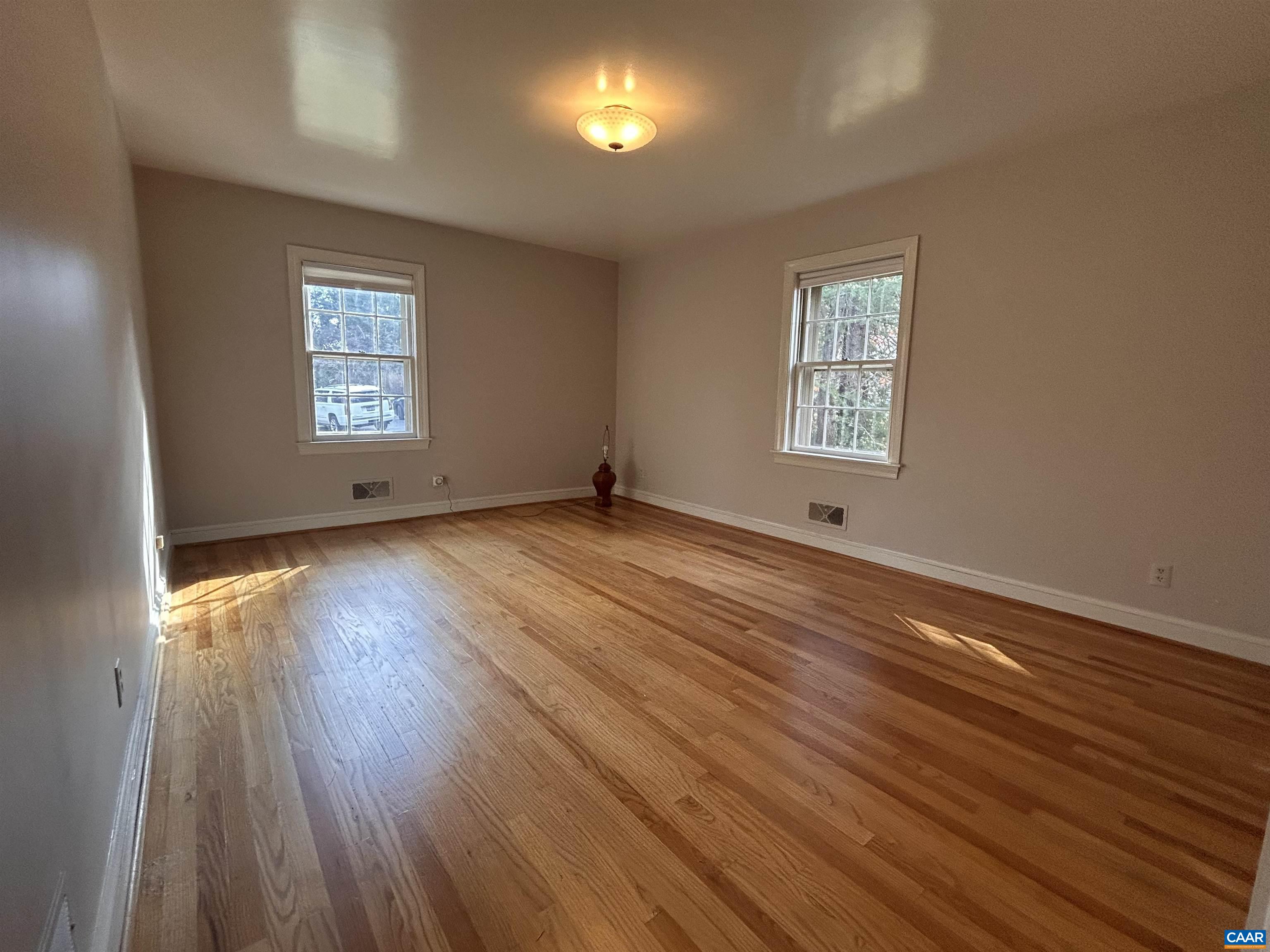 214 Montvue Drive Charlottesville, VA 22901 - Photo 15 of 30 an empty room with wooden floor and windows