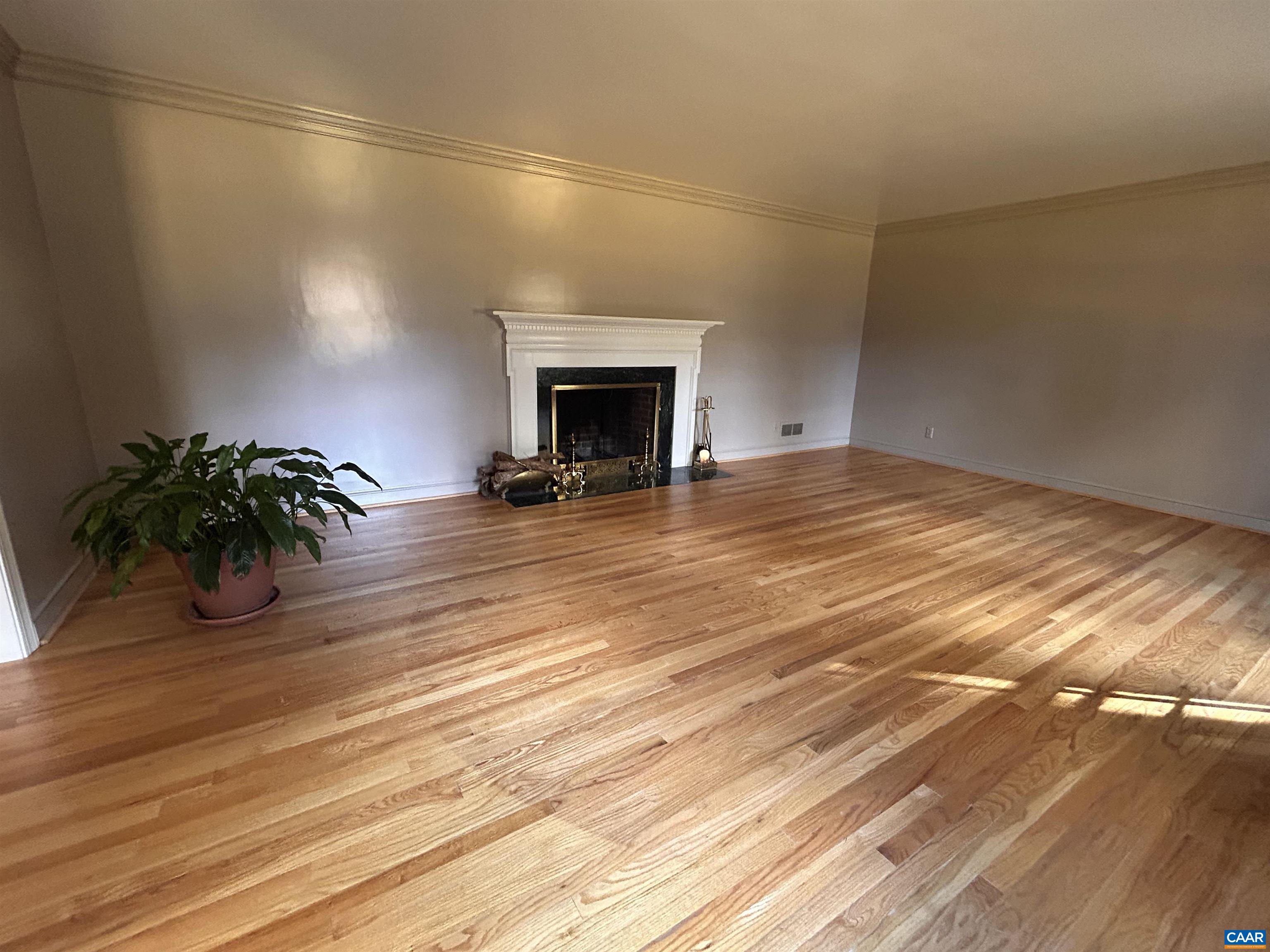 214 Montvue Drive Charlottesville, VA 22901 - Photo 5 of 30 a view of a room with wooden floor and a fireplace