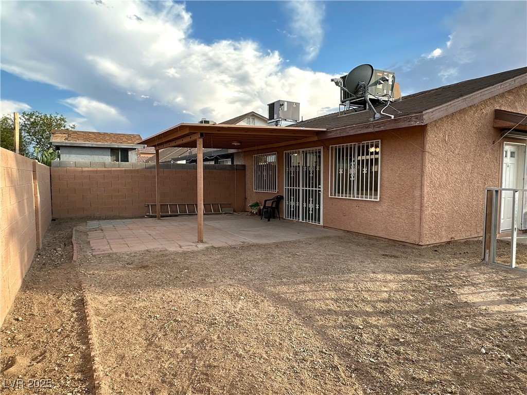 3936 Rive Gauche Street Las Vegas, NV 89115 - Photo 27 of 30 Back of property with a patio, a fenced backyard, central air condition unit, and stucco siding