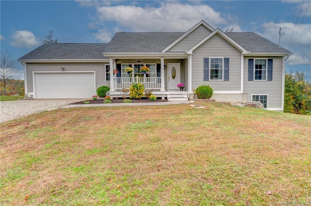 45 Szegda Road Columbia, CT 06237 - Photo 1 of 1 a front view of house with yard and trees in the background