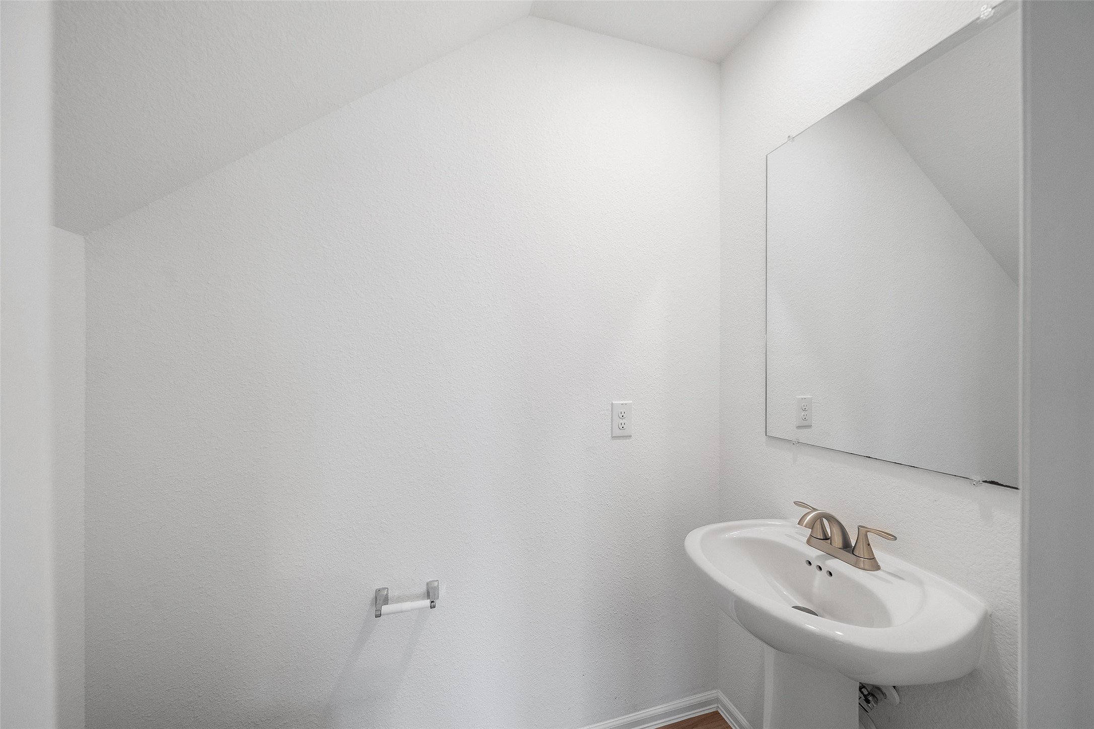 234 Bennett Street Angleton, TX 77515 - Photo 13 of 33 This charming downstairs half bath offers a sleek, modern design with a crisp white palette, perfect for guests and convenience.