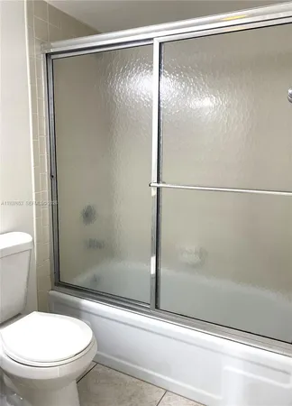 a bathroom with a toilet and a mirror