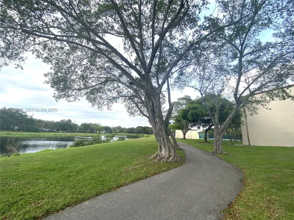 a view of building with yard in front of it