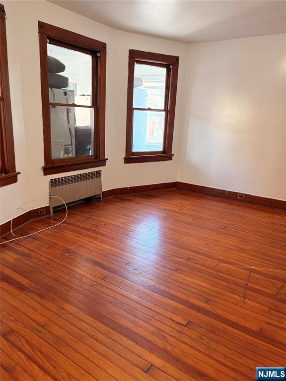 35 Marsellus Place, Unit 1 Garfield, NJ 07026 - Photo 11 of 37 an empty room with wooden floor and windows