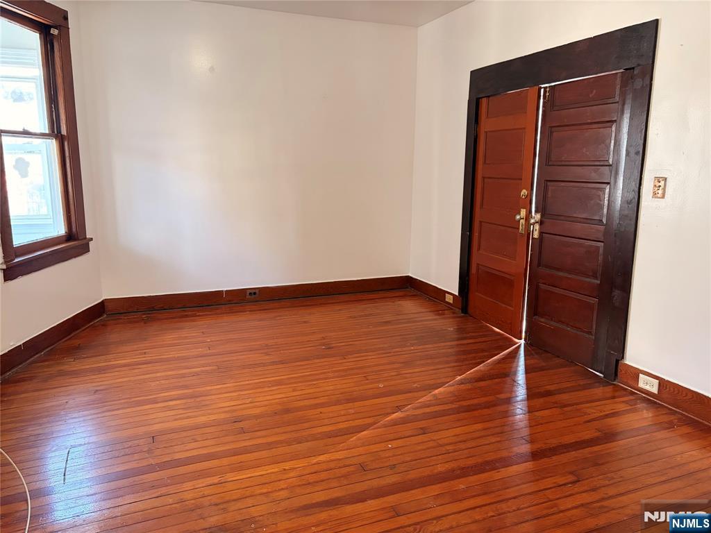 35 Marsellus Place, Unit 1 Garfield, NJ 07026 - Photo 12 of 37 an empty room with wooden floor and windows