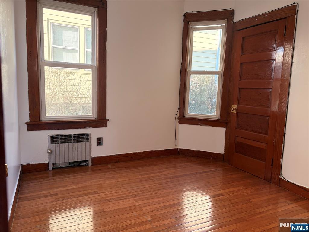 35 Marsellus Place, Unit 1 Garfield, NJ 07026 - Photo 18 of 37 an empty room with wooden floor and windows