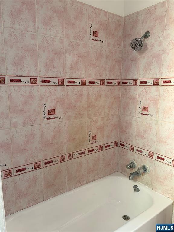 35 Marsellus Place, Unit 1 Garfield, NJ 07026 - Photo 22 of 37 a view of a bathroom with a tub and a shower