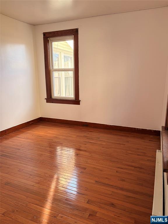 35 Marsellus Place, Unit 1 Garfield, NJ 07026 - Photo 29 of 37 a view of an empty room with wooden floor and a window