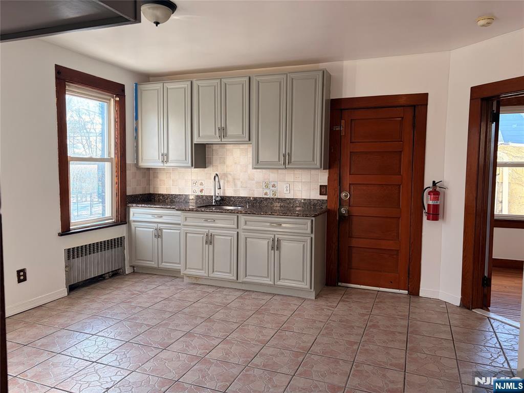 35 Marsellus Place, Unit 1 Garfield, NJ 07026 - Photo 33 of 37 a kitchen with a stove sink and cabinets