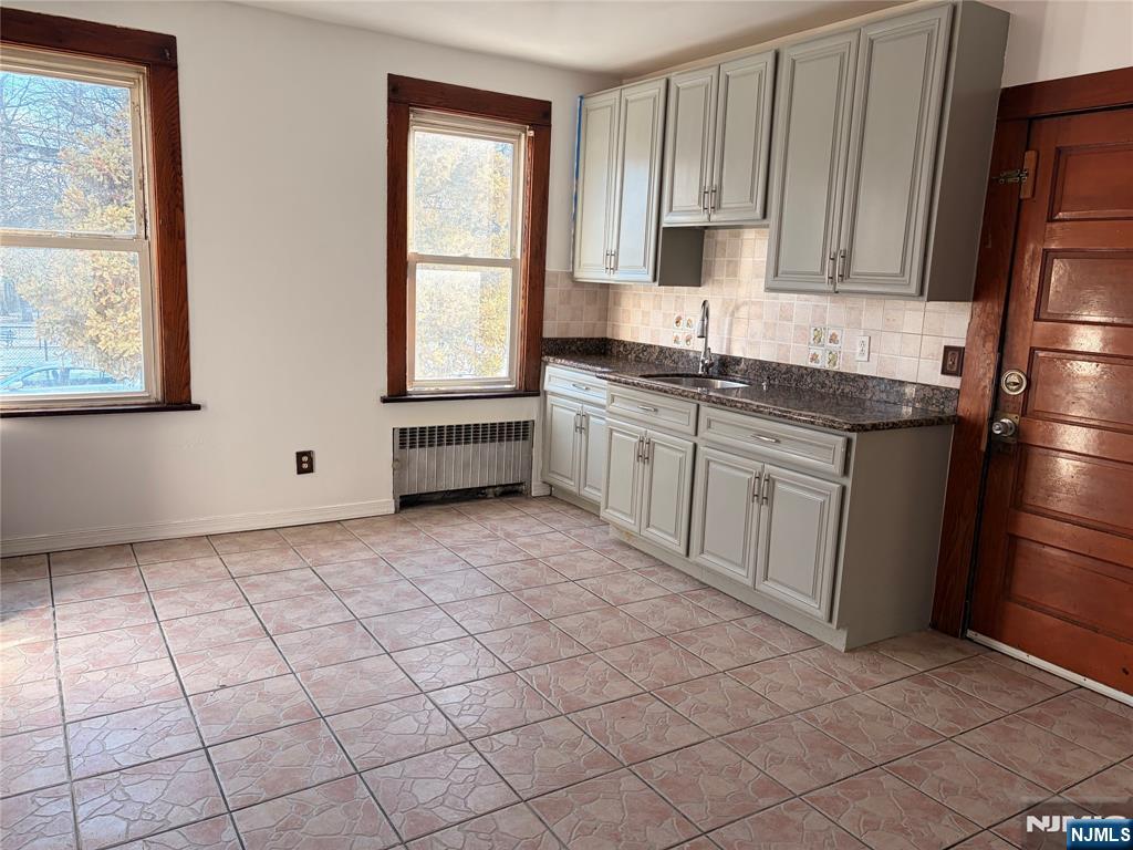 35 Marsellus Place, Unit 1 Garfield, NJ 07026 - Photo 34 of 37 a kitchen with stainless steel appliances granite countertop a stove a sink and a refrigerator
