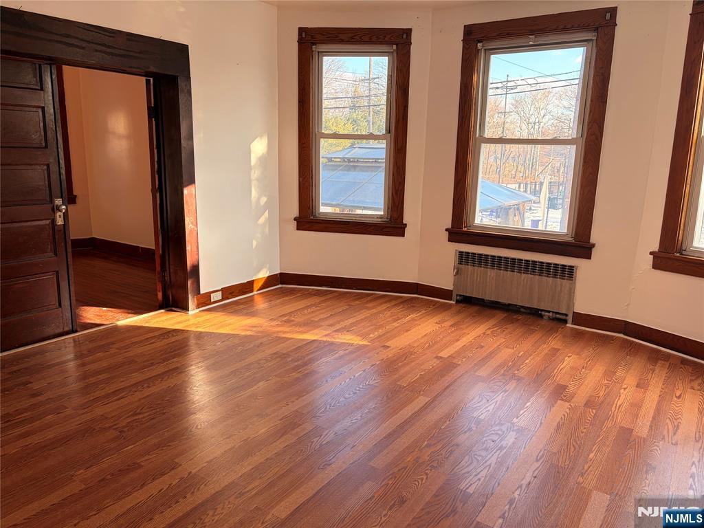 35 Marsellus Place, Unit 1 Garfield, NJ 07026 - Photo 36 of 37 an empty room with wooden floor and windows