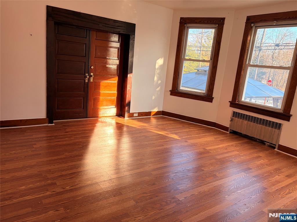 35 Marsellus Place, Unit 1 Garfield, NJ 07026 - Photo 37 of 37 an empty room with wooden floor and windows
