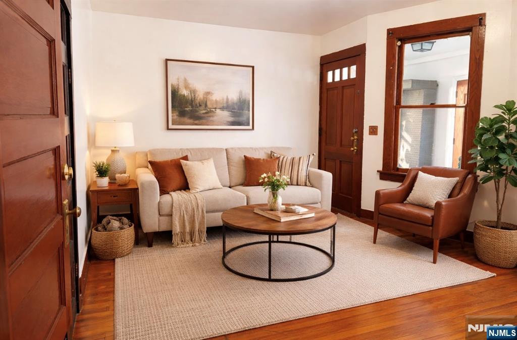 35 Marsellus Place, Unit 1 Garfield, NJ 07026 - Photo 5 of 37 a living room with furniture a large window and a flat screen tv