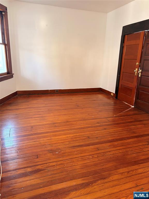 35 Marsellus Place, Unit 1 Garfield, NJ 07026 - Photo 10 of 37 a view of an empty room with wooden floor and a window