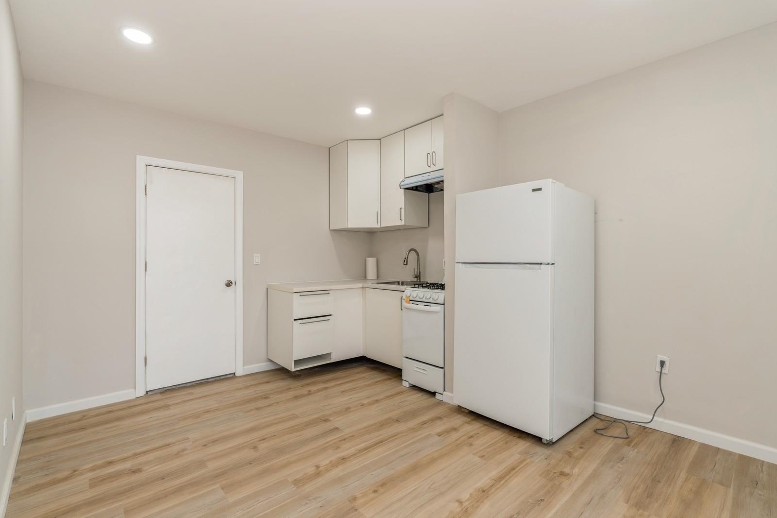 40 Beacon Avenue, Unit 5 Jersey City, NJ 07306 - Photo 16 of 20 a kitchen with white cabinets and white appliances