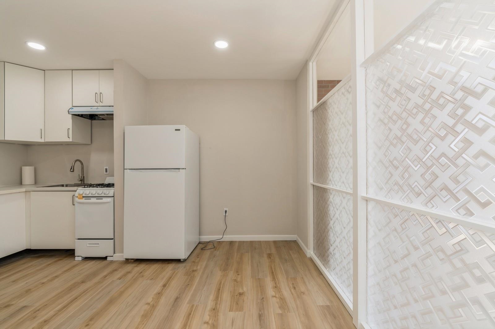 40 Beacon Avenue, Unit 5 Jersey City, NJ 07306 - Photo 17 of 20 a view of a kitchen with wooden floor