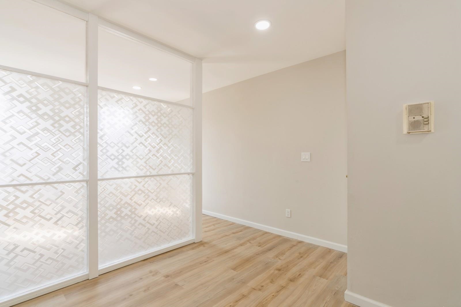 40 Beacon Avenue, Unit 5 Jersey City, NJ 07306 - Photo 6 of 20 a view of an empty room with wooden floor and a window