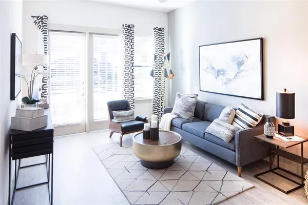a living room with furniture and a large window