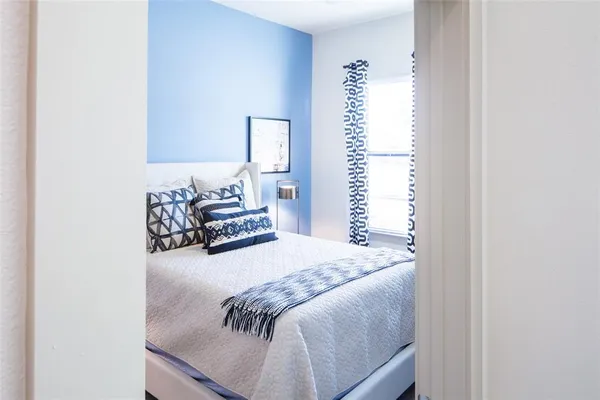 a bedroom with furniture and a wooden floor