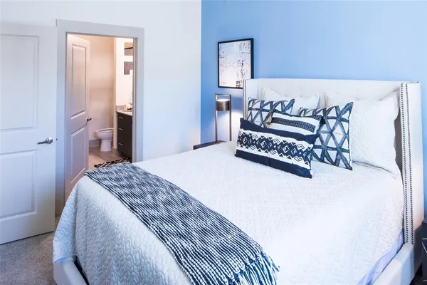 a bedroom with a bed and a table