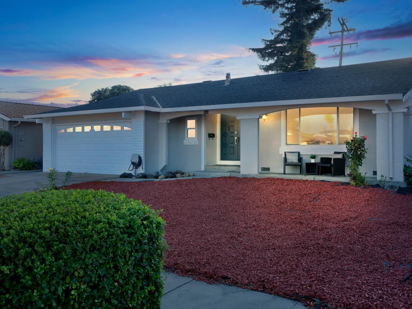 a view of a house with backyard and a garden