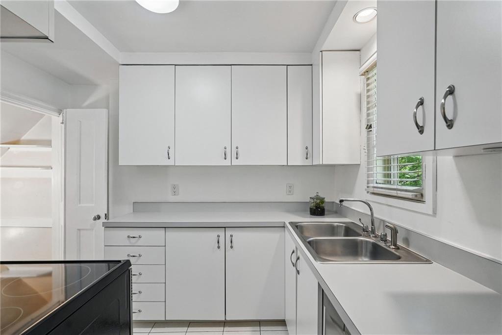 446 Olympia Road Pittsburgh, PA 15211 - Photo 12 of 31 a kitchen with granite countertop white cabinets and sink