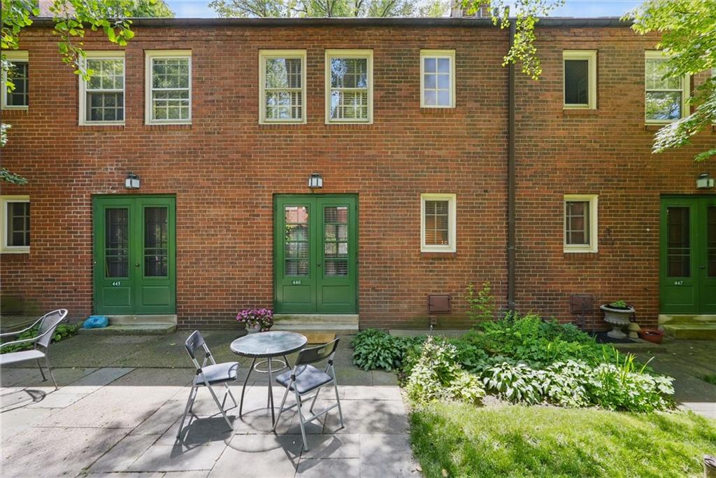 446 Olympia Road Pittsburgh, PA 15211 - Photo 24 of 31 a view of a brick house with chairs and table in a patio