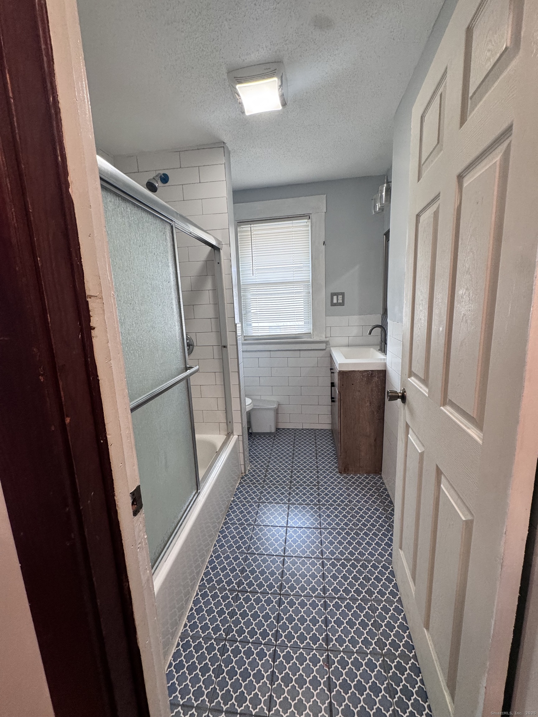 62 Marne Street Hamden, CT 06514 - Photo 17 of 26 a kitchen with a refrigerator and a sink
