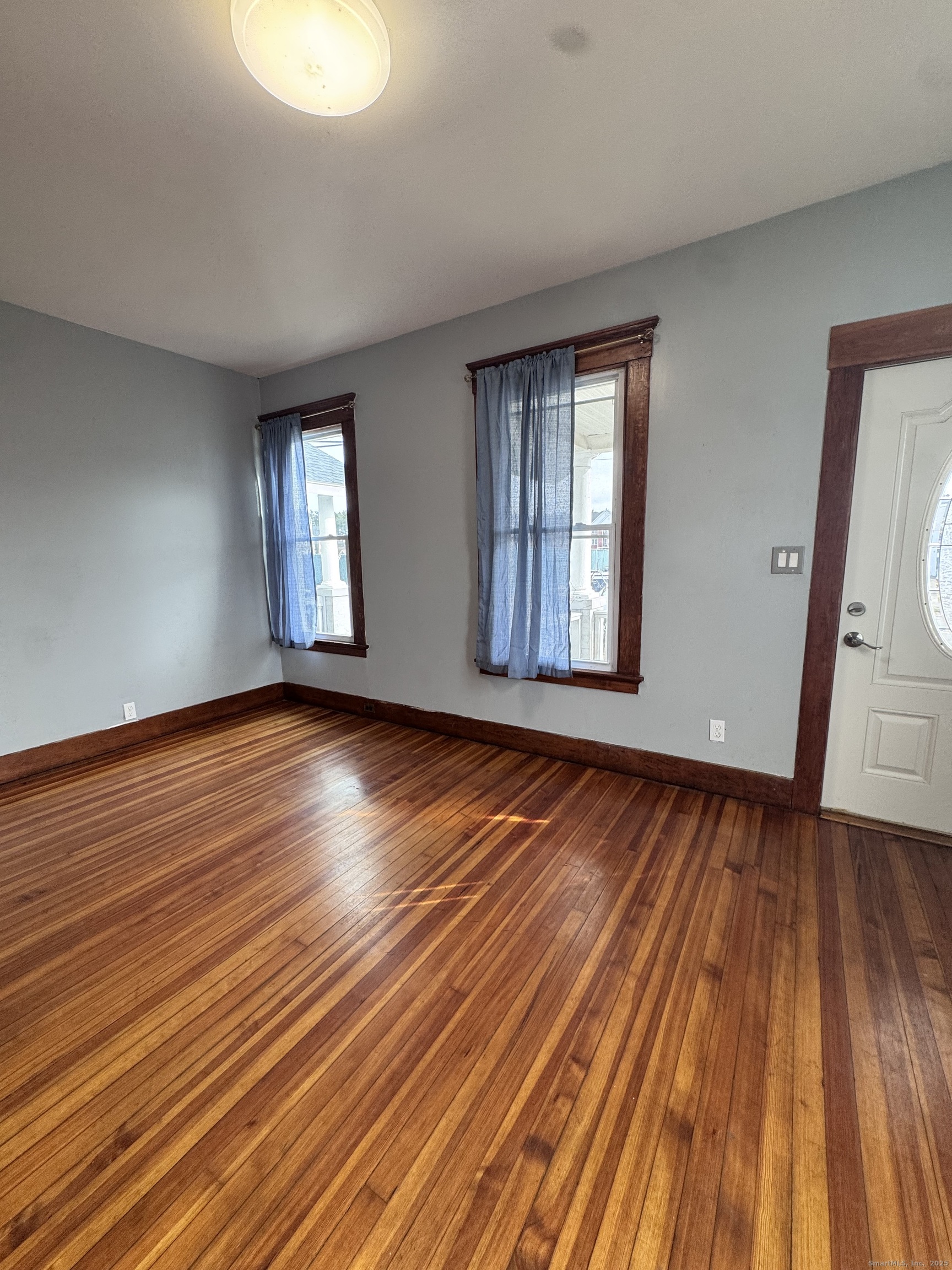 62 Marne Street Hamden, CT 06514 - Photo 4 of 26 a view of an empty room with wooden floor and window