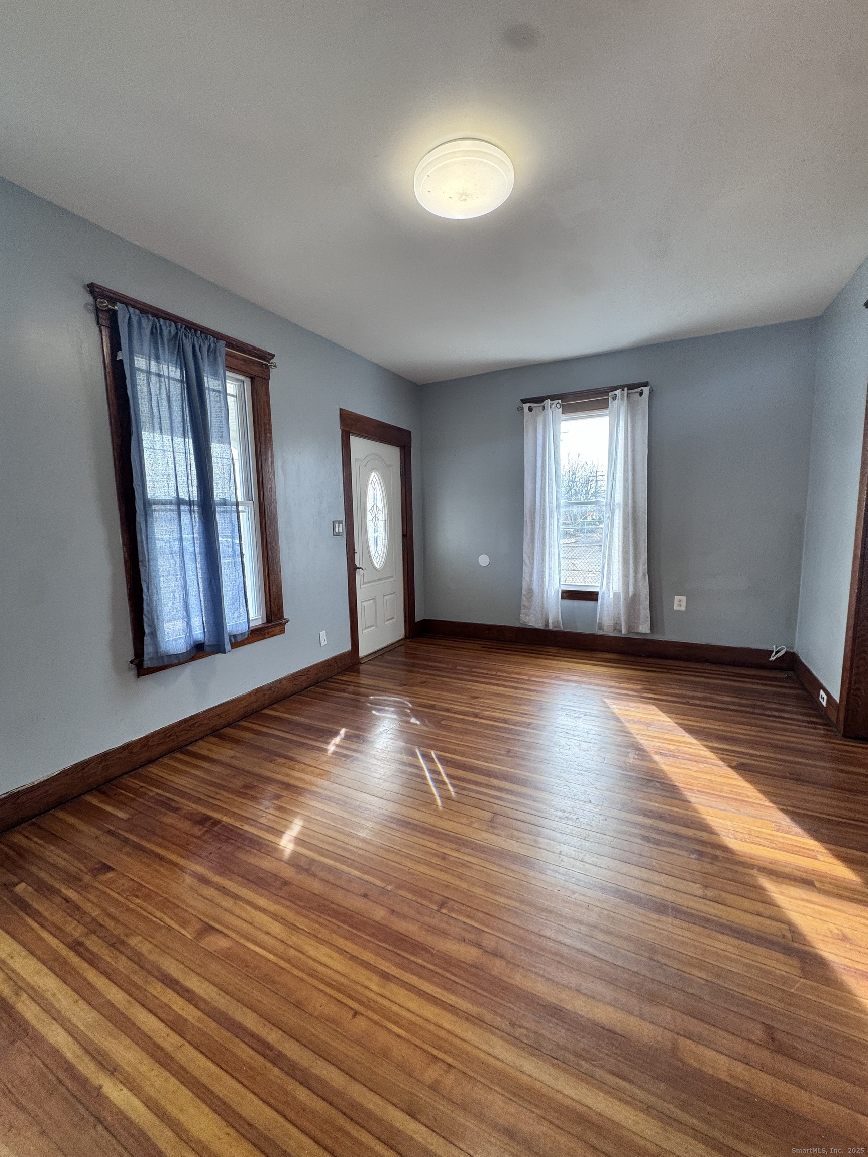 62 Marne Street Hamden, CT 06514 - Photo 5 of 26 a view of an empty room with window and wooden floor