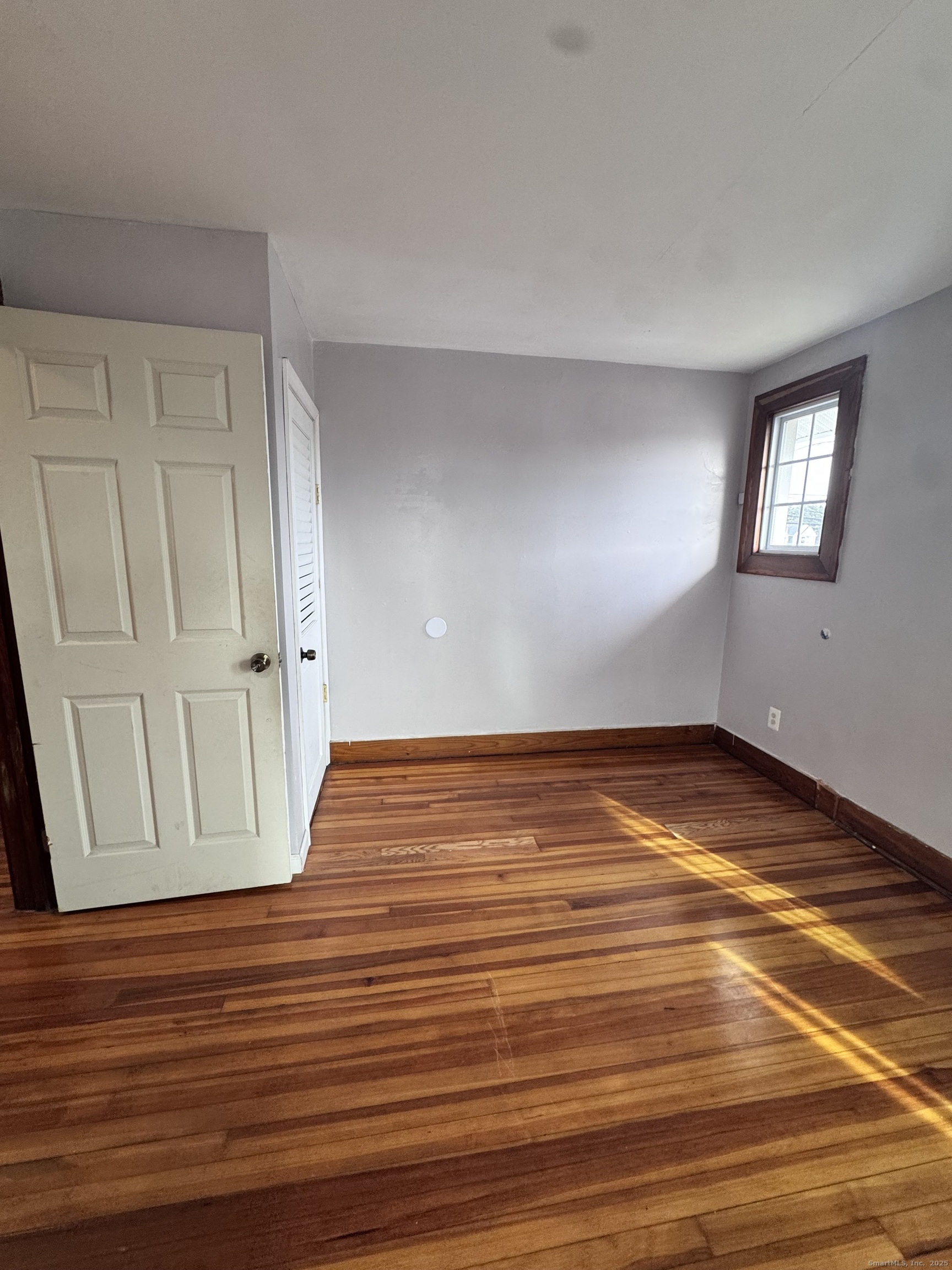 62 Marne Street Hamden, CT 06514 - Photo 7 of 26 a view of empty room with wooden floor and fan