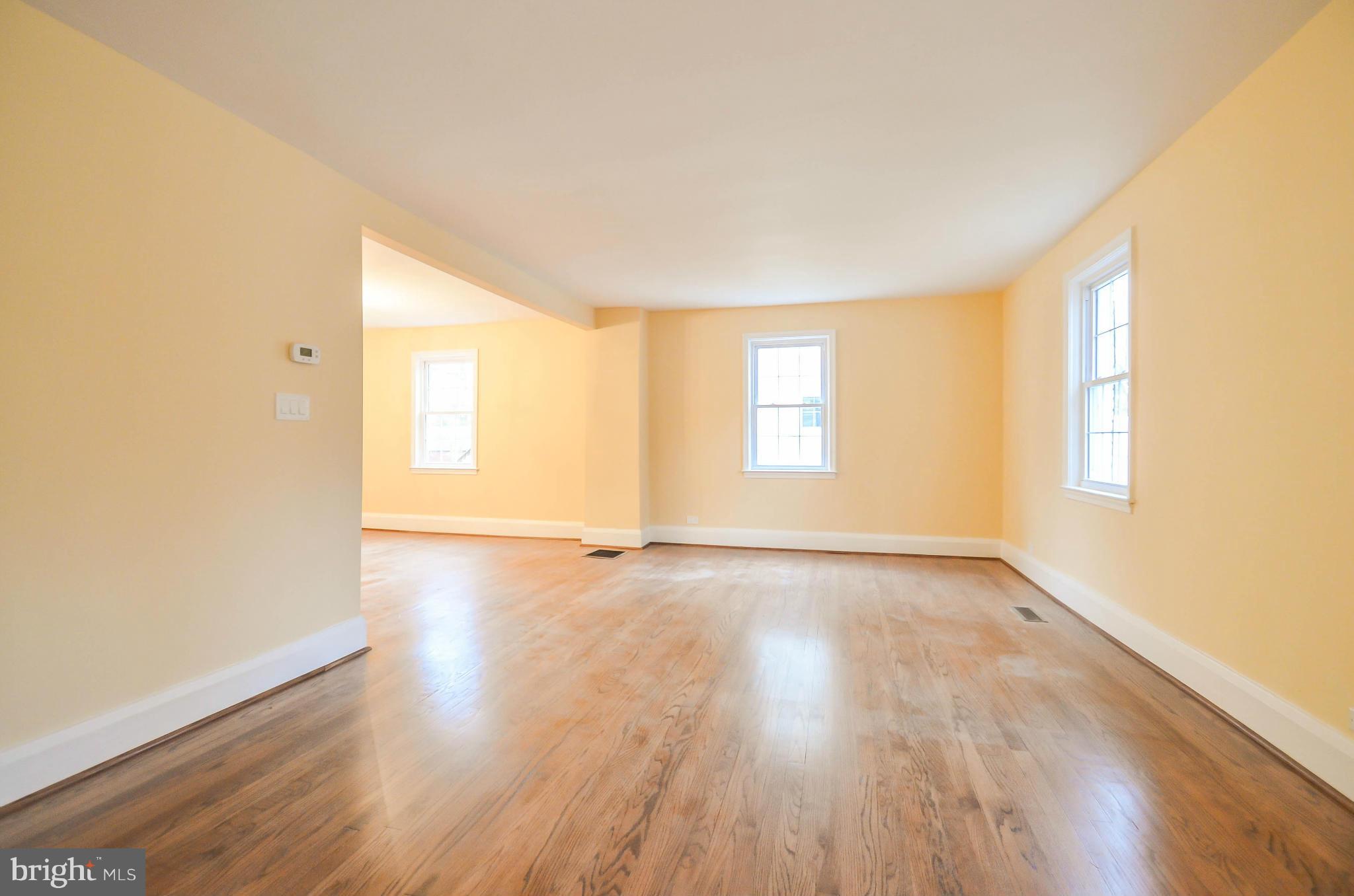 720 Overbrook Road Baltimore, MD 21212 - Photo 2 of 26 an empty room with wooden floor and windows