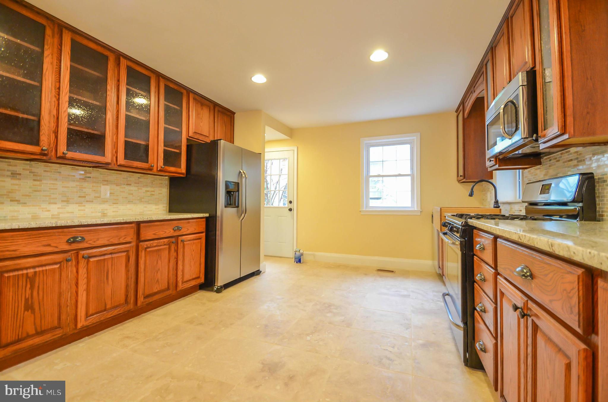 720 Overbrook Road Baltimore, MD 21212 - Photo 11 of 26 a spacious bathroom with a granite countertop sink and a washing machine