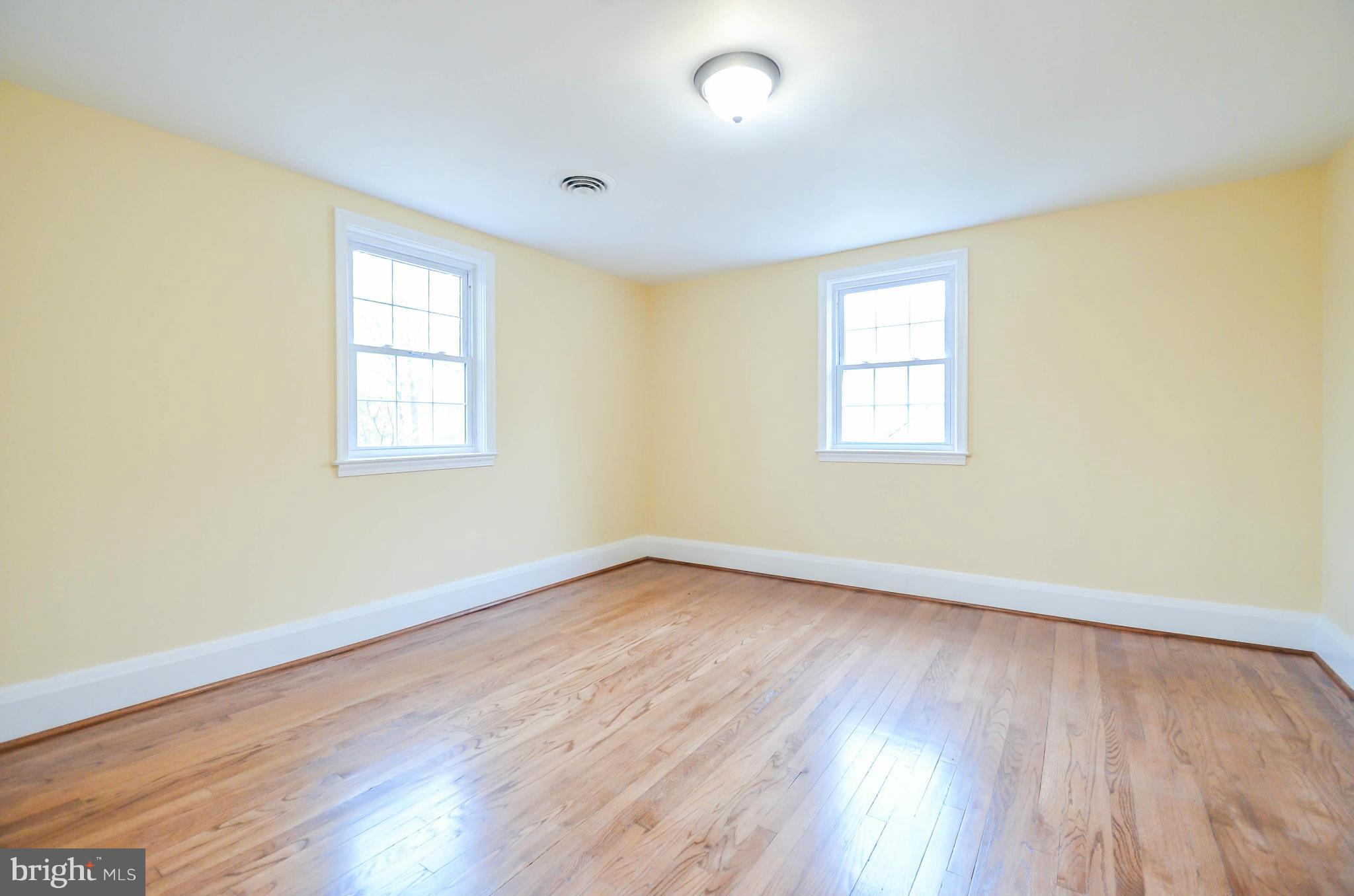 720 Overbrook Road Baltimore, MD 21212 - Photo 15 of 26 an empty room with wooden floor and windows