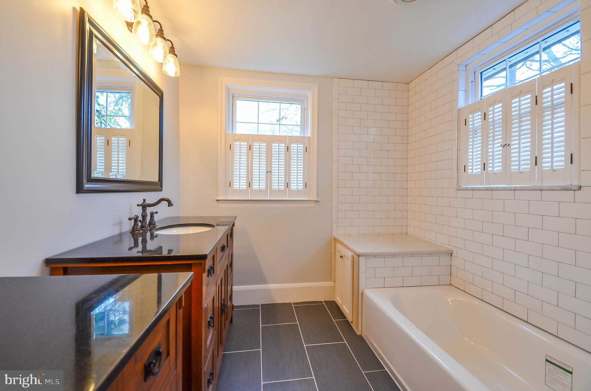 720 Overbrook Road Baltimore, MD 21212 - Photo 16 of 26 a bathroom with a tub sink and mirror