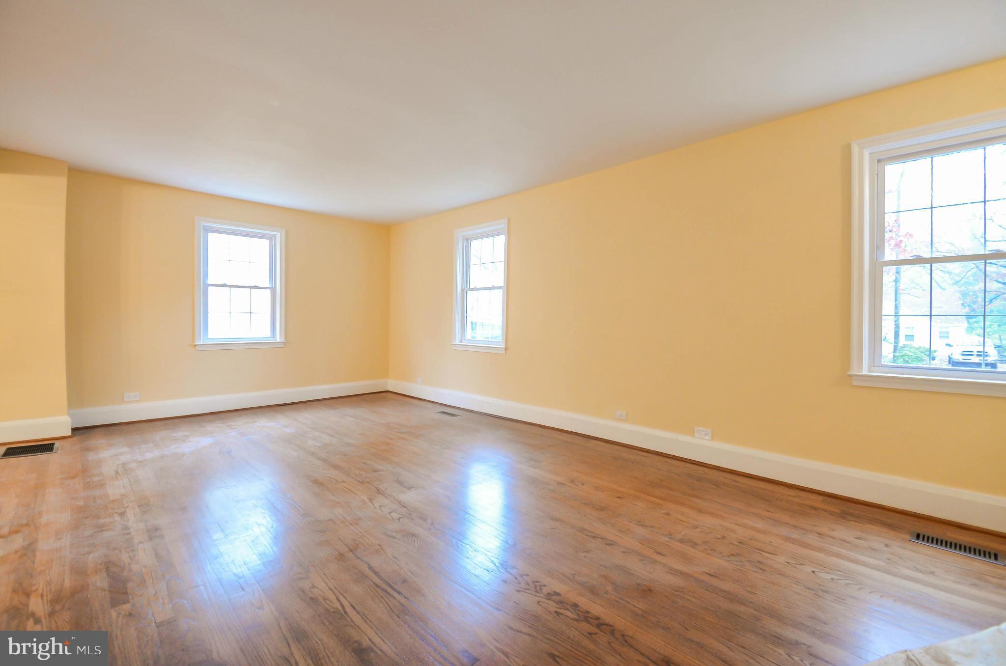 720 Overbrook Road Baltimore, MD 21212 - Photo 3 of 26 an empty room with wooden floor and windows