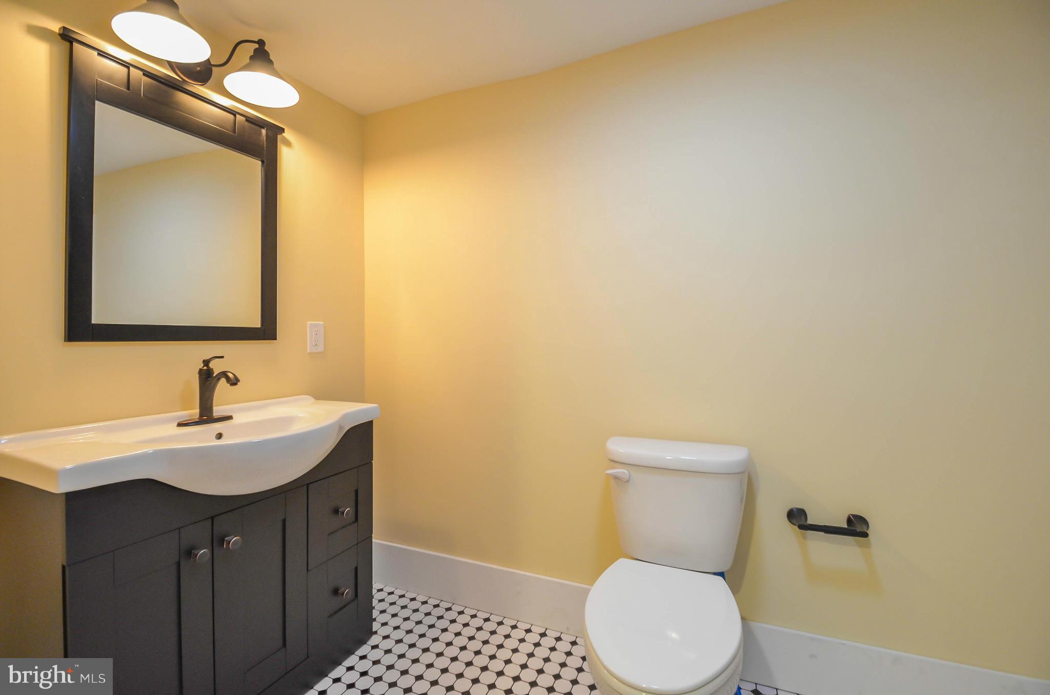 720 Overbrook Road Baltimore, MD 21212 - Photo 21 of 26 a bathroom with a toilet a sink and mirror