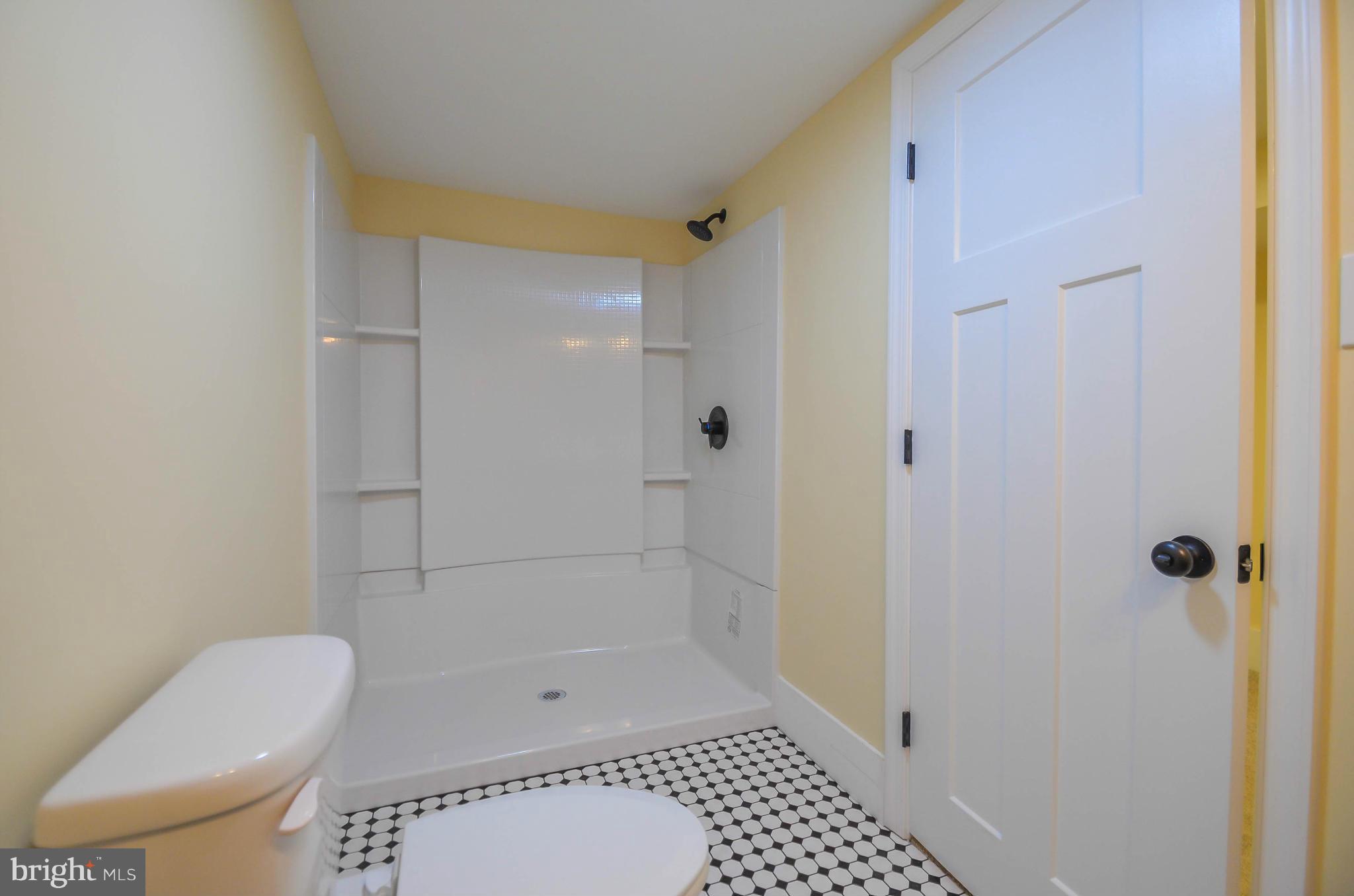 720 Overbrook Road Baltimore, MD 21212 - Photo 22 of 26 a bathroom with a shower a toilet and a sink