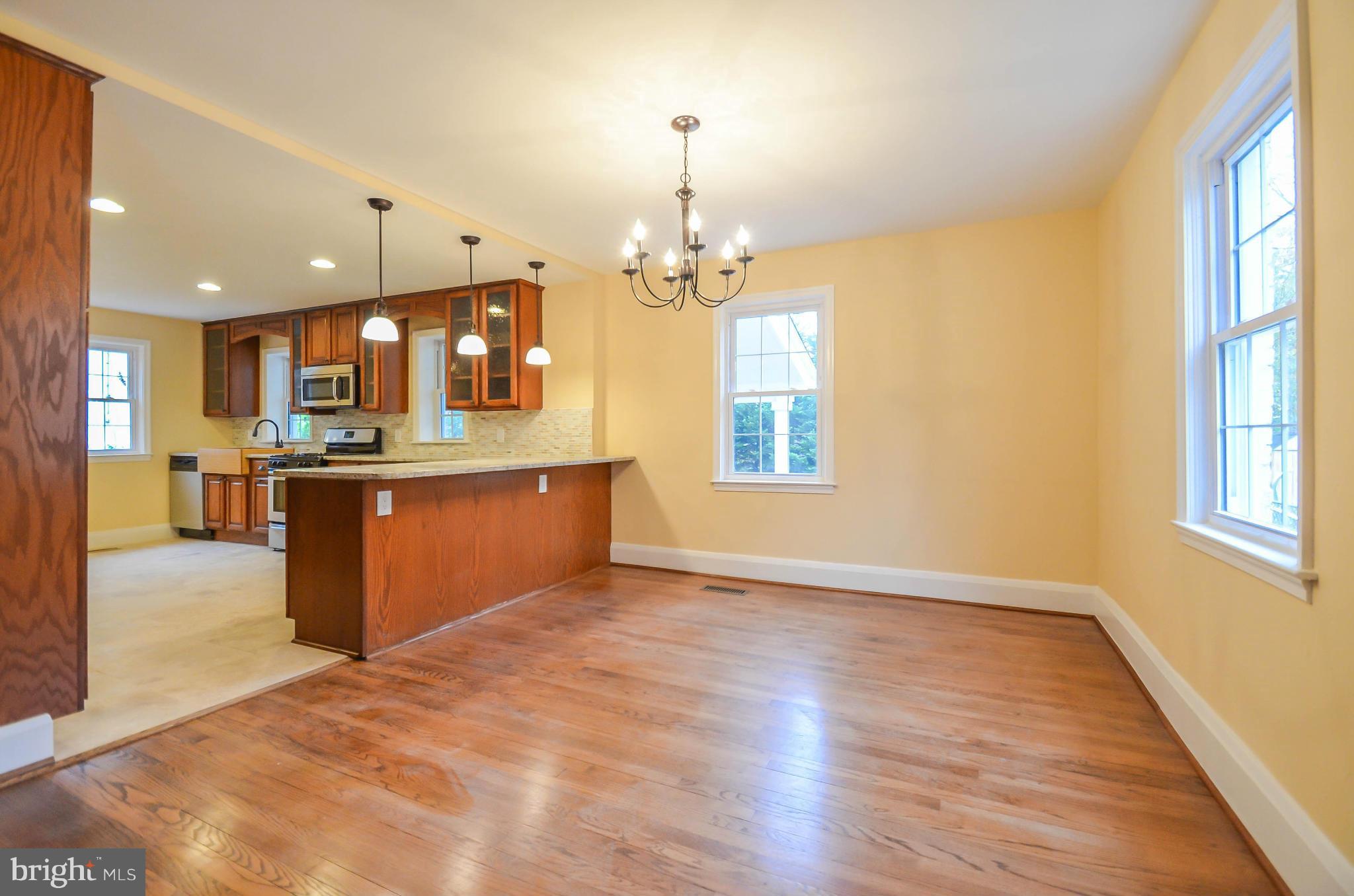 720 Overbrook Road Baltimore, MD 21212 - Photo 4 of 26 a view of a kitchen with a stove cabinets and wooden floor