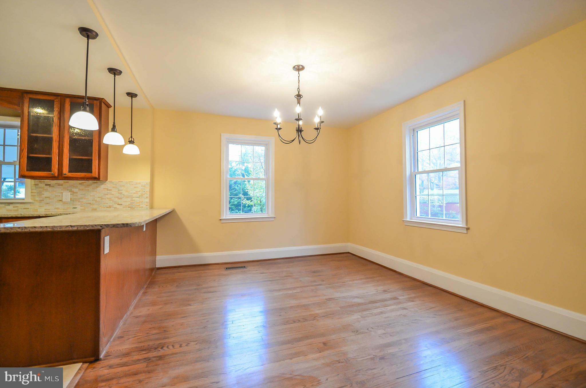 720 Overbrook Road Baltimore, MD 21212 - Photo 5 of 26 a view of an empty room with window and wooden floor