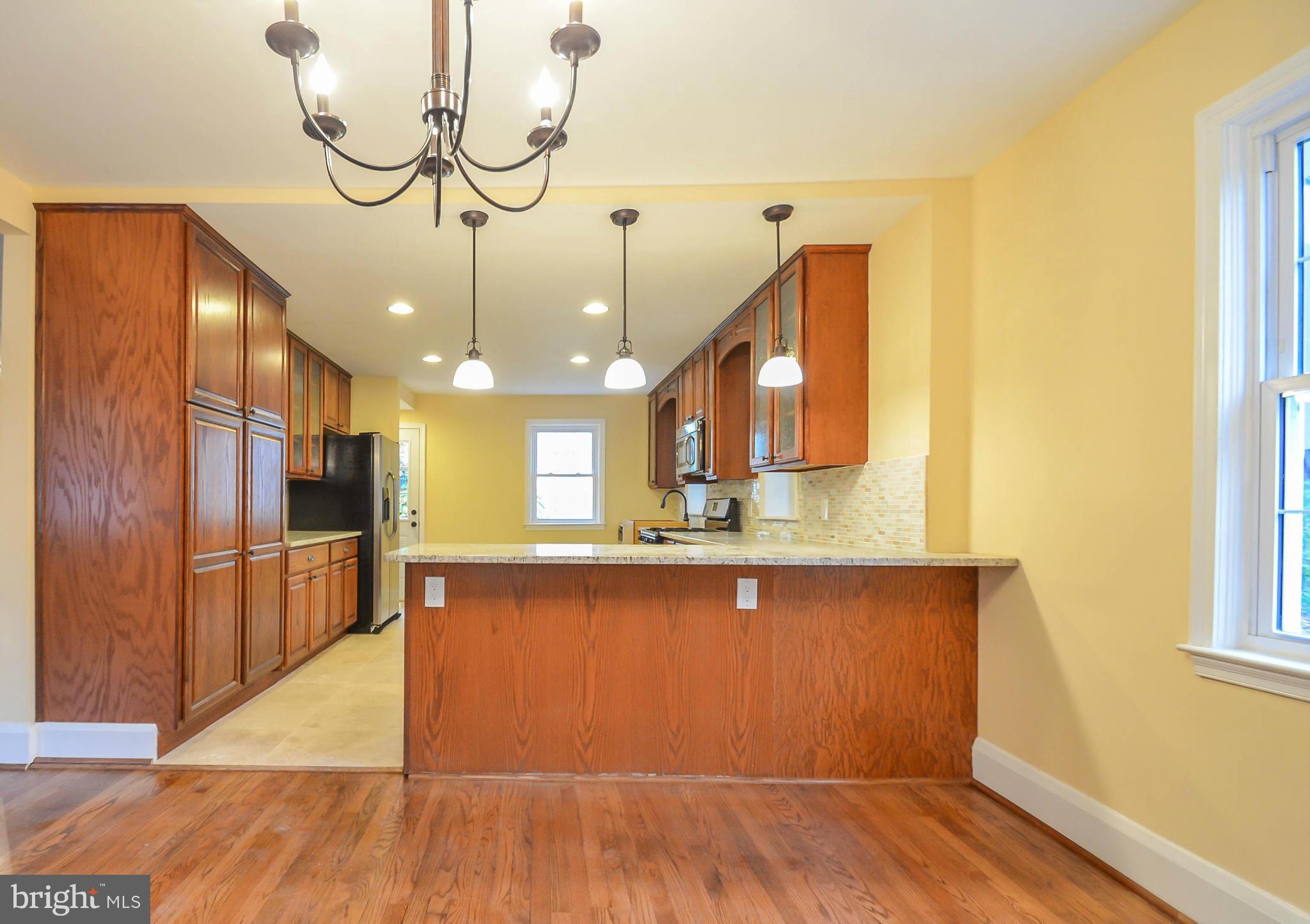 720 Overbrook Road Baltimore, MD 21212 - Photo 7 of 26 a view of a kitchen with a sink and wooden floor