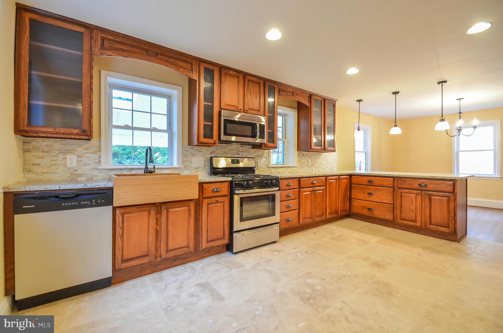 720 Overbrook Road Baltimore, MD 21212 - Photo 8 of 26 a large kitchen with stainless steel appliances granite countertop a stove and a sink