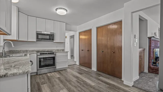 a kitchen with granite countertop a stove and a refrigerator