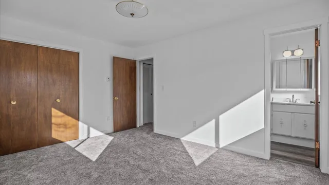 a bathroom with a granite countertop sink and a toilet