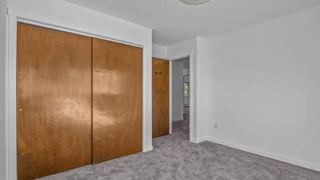a view of a room with lots of wooden furniture