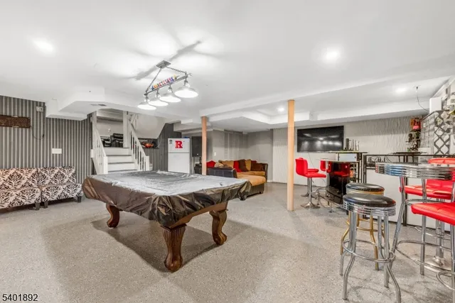 a living room with furniture and kitchen view