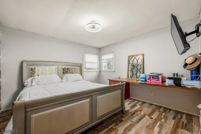 a bedroom with a bed and a dresser in it