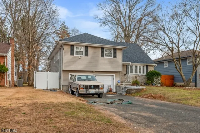 a car parked in front of white house