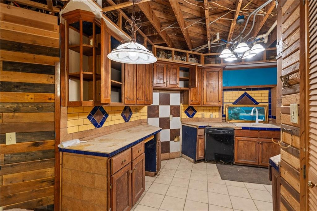 263 Buncombe-Waco Road Waco, GA 30182 - Photo 13 of 14 a view of a kitchen with kitchen island a stove a sink and a microwave