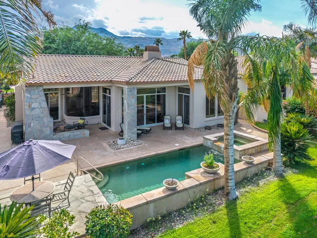 an aerial view of a golf course with a lake view